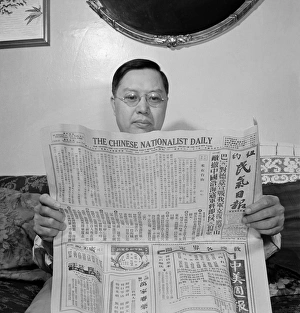 READING, 1942. A Chinese-American man reading The Chinese Nationalist Daily newspaper READING, 1942. A Chinese-American man reading The Chinese Nationalist Daily newspaper