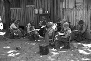 Schoolboys reading books in an outdoor classroom for migrant children at Skyline Farms, near Scottsboro, Alabama Schoolboys reading books in an outdoor classroom for migrant children at Skyline Farms, near Scottsboro, Alabama