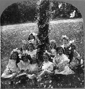 Schoolgirls sitting around a decorated tree used for a Maypole in celebration of May Day Schoolgirls sitting around a decorated tree used for a Maypole in celebration of May Day