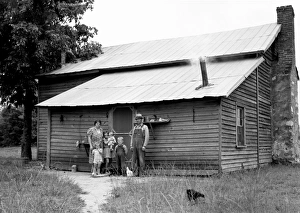 SHARECROPPER, 1939. A tobacco sharecropper with his family at the back of their SHARECROPPER, 1939. A tobacco sharecropper with his family at the back of their