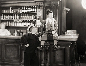 <b class=qtipBold><figcaption>Silent Film Still: Drinking</figcaption></b><br>Silent Film Still: Drinking.<br><em>© none</em> Silent Film Still: Drinking