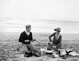SILENT FILM STILL: PICNIC. Beach picnic, late 1920s