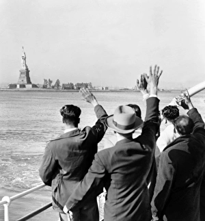 STATUE OF LIBERTY. Part of a group of illegal immigrants waving goodbye to the Statue of STATUE OF LIBERTY. Part of a group of illegal immigrants waving goodbye to the Statue of