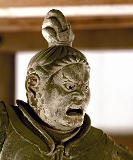 Statue of a warrior demigod, his face indicating wrath, one of the deva gods who guards Statue of a warrior demigod, his face indicating wrath, one of the deva gods who guards
