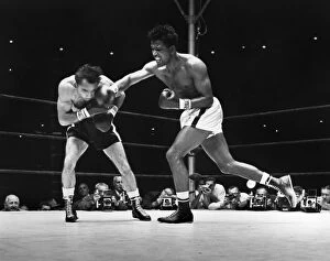 Robinson Collection: SUGAR RAY ROBINSON (1921-1989). Robinson (right) during the seventh round of a fight