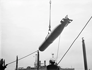 TORPEDO, 1913. Sailors manuevering a torpedo on board an American warship. Photograph TORPEDO, 1913. Sailors manuevering a torpedo on board an American warship. Photograph