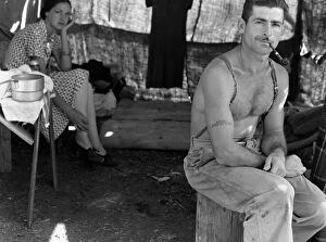 New Deal Gallery: An unemployed lumberjack with his wife in a migrant workers camp for the bean harvest
