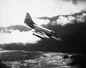 A U.S. Navy A4 Skyhawk dropping a bomb on Viet Cong forces in South Vietnam, 1965