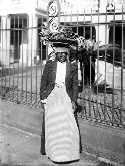 VEGETABLE VENDOR, c1900. A New Orleans woman vendor carrying her vegetables in