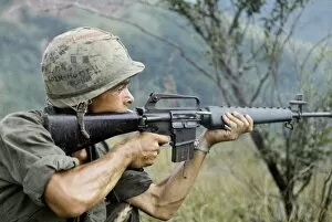 Mendoza Gallery: VIETNAM WAR, 1967. Private Michael Mendoza firing a M-16 rifle in the direction of sniper fire
