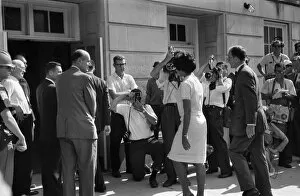 Vivian Malone entering Foster Auditorium to become one of the first black students to attend the University of Alabama on 11 June 1963, passing through a crowd that includes photographers, National Guard members, and Deputy U.S. Attorney General Nicholas Katzenbach. Photographed by Warren K. Leffler