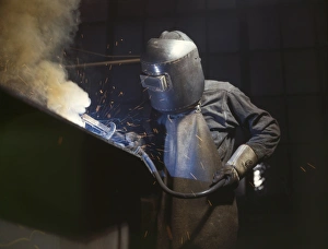 WELDER, 1942. An employee of the Combustion Engineering Company making boilers WELDER, 1942. An employee of the Combustion Engineering Company making boilers