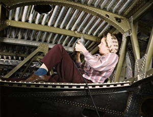 A woman riveter working on an A-20 Havoc light attack bomber at the Douglas Aircraft A woman riveter working on an A-20 Havoc light attack bomber at the Douglas Aircraft