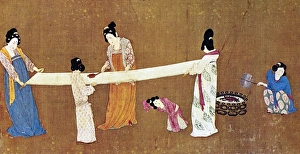 Women ironing a completed bolt of silk cloth. Detail from Court Ladies Preparing Women ironing a completed bolt of silk cloth. Detail from Court Ladies Preparing