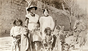 WWI: REFUGEES, 1918. Miss Fisher, an American Red Cross worker, with orphan children WWI: REFUGEES, 1918. Miss Fisher, an American Red Cross worker, with orphan children