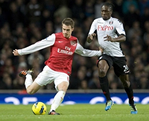 Aaron Ramsey of Arsenal takes on Dickson Etuhu of Fulham during the Barclays Premier Aaron Ramsey of Arsenal takes on Dickson Etuhu of Fulham during the Barclays Premier