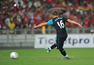 Aaron Ramsey shoots past Malaysia goalkeeper Khairul Che Mat to score the 1st Arsenal goal Aaron Ramsey shoots past Malaysia goalkeeper Khairul Che Mat to score the 1st Arsenal goal