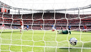 Aaron Ramsey shoots past Portsmouth goalkeeper David Aaron Ramsey shoots past Portsmouth goalkeeper David