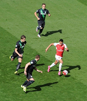 Alexis Sanchez (Arsenal) takes on Xherdan Shaqiri, Marco van Ginkel and Phil Bardsley Alexis Sanchez (Arsenal) takes on Xherdan Shaqiri, Marco van Ginkel and Phil Bardsley
