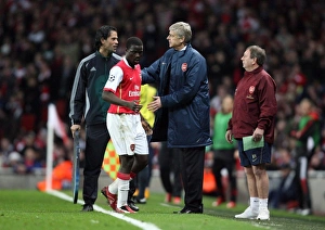 Arsenal manager Arsene Wenger pats Emmanuel Eboue on the back after his substitution Arsenal manager Arsene Wenger pats Emmanuel Eboue on the back after his substitution