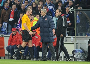 Arsenal manager Arsene Wenger talks to referee Martin Hansson after the 2nd Porto goal Arsenal manager Arsene Wenger talks to referee Martin Hansson after the 2nd Porto goal
