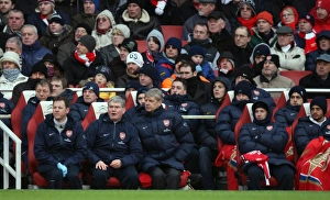 Arsene Wenger the Arsenal Manager sits in the dug out with Pat Rice (Assistant) Arsene Wenger the Arsenal Manager sits in the dug out with Pat Rice (Assistant)