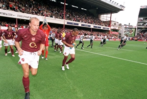Dennis Bergkamp and Thierry Henry (Arsenal) run out at the start of the match Dennis Bergkamp and Thierry Henry (Arsenal) run out at the start of the match