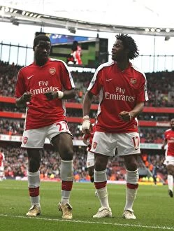 Images Dated 14th March 2009: Emmanuel Eboue celebrates scoring the 4th Arsenal goal with Alex Song