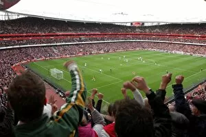 Fans Collection: Fans jump up in the upper terrace to celebrate Emmanuel Adebayor scoring Arsenals 1st goal