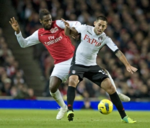 Johan Djourou of Arsenal takes on Clint Dempsey of Fulham during the Barclays Premier Johan Djourou of Arsenal takes on Clint Dempsey of Fulham during the Barclays Premier