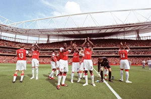 Kolo Toure and Johan Djourou (Arsenal) clap the fans along with the rest of the team Kolo Toure and Johan Djourou (Arsenal) clap the fans along with the rest of the team