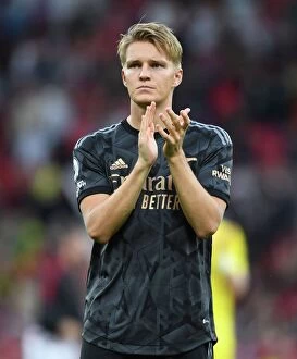 Manchester United F Collection: Martin Odegaard's Triumphant Celebration: Arsenal Fans Go Wild After Manchester United Defeat