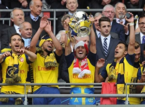 Mathieu Flamini, Francis Coquelin, Santi Cazorla and Alexis Sanchez lift the FA Cup after Mathieu Flamini, Francis Coquelin, Santi Cazorla and Alexis Sanchez lift the FA Cup after