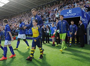 Per Mertesacker (Arsenal) with the Arsenal Mascot. Leicester City 1:1 Arsenal. Barclays Per Mertesacker (Arsenal) with the Arsenal Mascot. Leicester City 1:1 Arsenal. Barclays