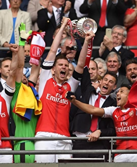 Images Dated 3rd January 2016: Per Mertesacker and Laurent Koscielny (Arsenal) lift the FA Cup. Arsenal 2: 1 Chelsea