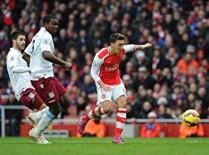 Mesut Ozil scores Arsenals 2nd goal under pressure from Jores Okore and Carles Gil (Villa) Mesut Ozil scores Arsenals 2nd goal under pressure from Jores Okore and Carles Gil (Villa)