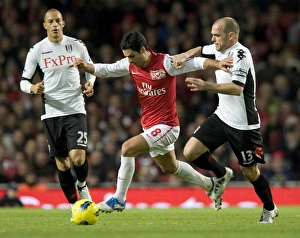 Mikel Arteta of Arsenal breaks past Danny Murphy of Fulham during the Barclays Premier Mikel Arteta of Arsenal breaks past Danny Murphy of Fulham during the Barclays Premier