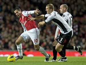 Robin van Persie of Arsenal breaks past Brede Hangeland of Fulham during the Barclays Robin van Persie of Arsenal breaks past Brede Hangeland of Fulham during the Barclays