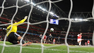 Robin van Persie shoots past Partizan goalkeeper Vladimir Stojkovic to score the 1st Robin van Persie shoots past Partizan goalkeeper Vladimir Stojkovic to score the 1st
