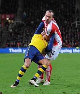 STOKE ON TRENT, ENGLAND - DECEMBER 06: Alexis Sanchez of Arsenal is fouled by Charlie STOKE ON TRENT, ENGLAND - DECEMBER 06: Alexis Sanchez of Arsenal is fouled by Charlie