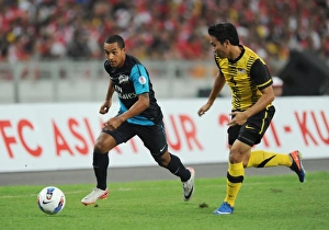 Theo Walcott (Arsenal) Mohd Putra (Malaysia). Malaysia XI 0:4 Arsenal, Bukit Jalil Stadium Theo Walcott (Arsenal) Mohd Putra (Malaysia). Malaysia XI 0:4 Arsenal, Bukit Jalil Stadium