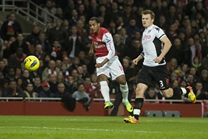 Theo Walcott of Arsenal shoots past John Arne Riise of Fulham during the Barclays Premier Theo Walcott of Arsenal shoots past John Arne Riise of Fulham during the Barclays Premier