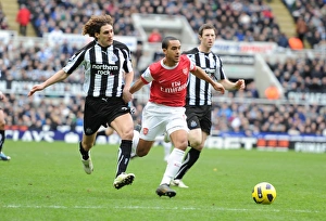 Theo Walcott breaks past Newcastle defender Fabricio Coloccini to score the 1st Arsenal Theo Walcott breaks past Newcastle defender Fabricio Coloccini to score the 1st Arsenal