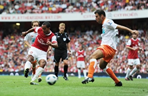 Theo Walcott shoots past Blackpool defender Dekel Keinan to score the 3rd Arsenal goal Theo Walcott shoots past Blackpool defender Dekel Keinan to score the 3rd Arsenal goal