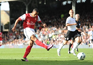 Theo Walcott shoots past Fulham goalkeeper Mark Schwarzer to score the 2nd Arsenal goal Theo Walcott shoots past Fulham goalkeeper Mark Schwarzer to score the 2nd Arsenal goal