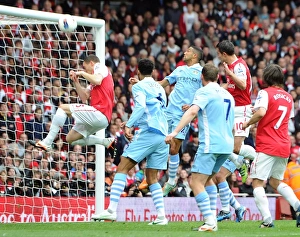 Thomas Vermaelen accidentally blocks Robin van Persie (Arsenal) goal bound header Thomas Vermaelen accidentally blocks Robin van Persie (Arsenal) goal bound header