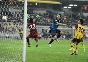 Tomas Rosicky heads past Malaysia goalkeeper Khairul Che Mat to score the 4th Arsenal goal Tomas Rosicky heads past Malaysia goalkeeper Khairul Che Mat to score the 4th Arsenal goal