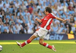Tomas Rosicky shoots past Man City goalkeeper Shay Tomas Rosicky shoots past Man City goalkeeper Shay