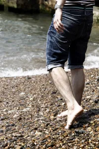 Man wearing striped T shirt on holiday at the seaside on the beach Man wearing striped T shirt on holiday at the seaside on the beach