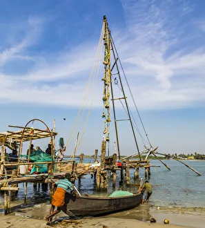 A fishing boat and the Chinese fishing nets at Fort Kochi in Kerala, India A fishing boat and the Chinese fishing nets at Fort Kochi in Kerala, India